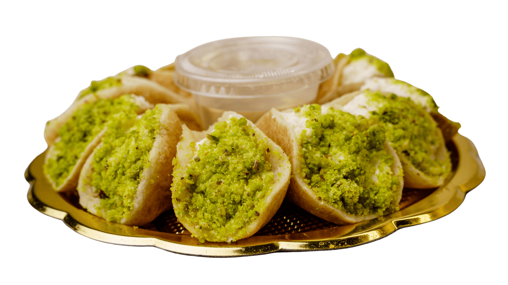 A tray of Qatayef Assafiri pastries by Pâtisserie Le Caramel with green sauce on it, available in Ottawa, Ontario.