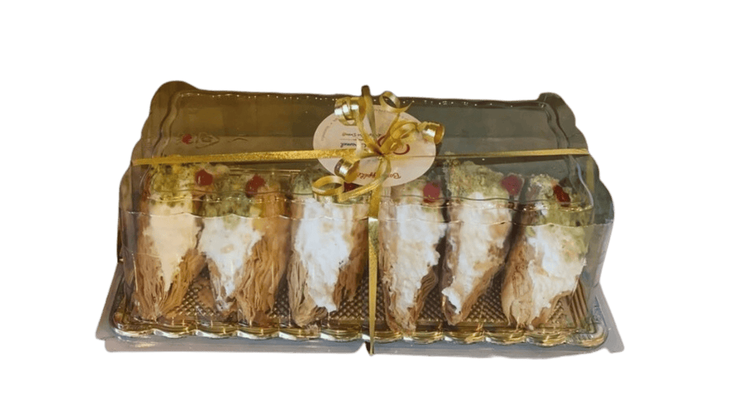 A box of Ottawa Ontario desserts from Pâtisserie Le Caramel, featuring Wardeh Lebanon pastries in a clear plastic box.