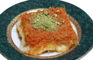 A plate with Kanafeh Nabulsi, a pastry, from Pâtisserie Le Caramel in Ottawa Ontario.